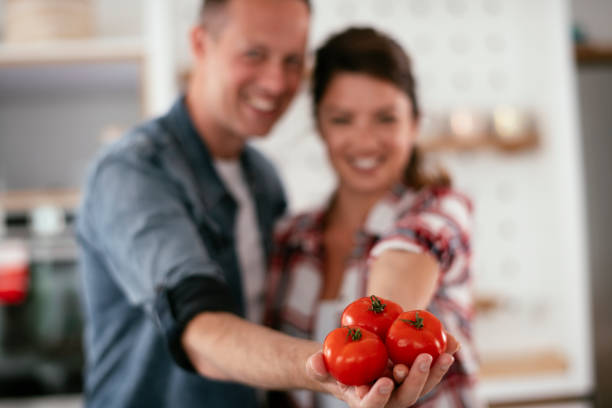 istock Loving couple eating sandwich in kitchen. 1272411433