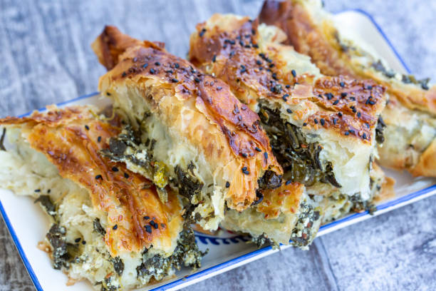 istock Traditional Turkish pastry with spinach. (Turkish Name: Ispanakli Kol Boregi, Bosnak boregi). Handmade pastry with spinach filling. 1272412449