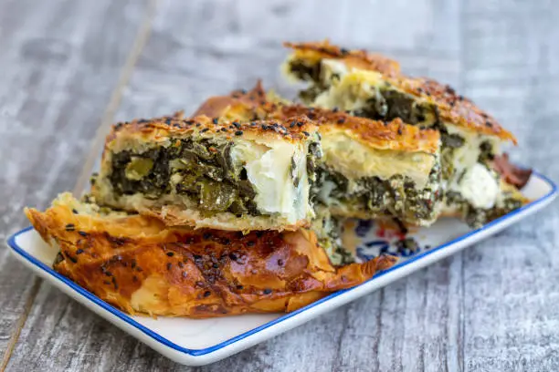 Traditional Turkish pastry with spinach. (Turkish Name: Ispanakli Kol Boregi, Bosnak boregi). Handmade pastry with spinach filling.