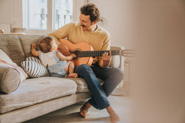 istock Father Playing Guitar for Baby 1272412884