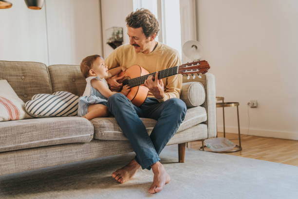 istock Father Playing Guitar for Baby 1272412925