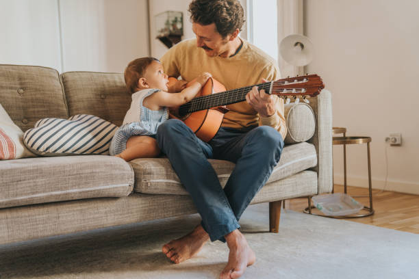 istock Father Playing Guitar for Baby 1272412950