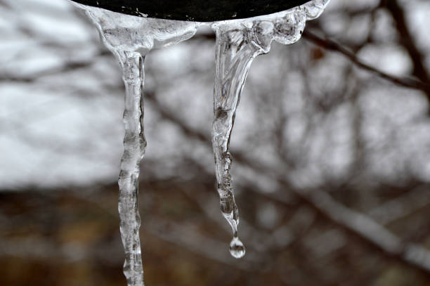 istock melting icicles hanging from the roof 1272413084