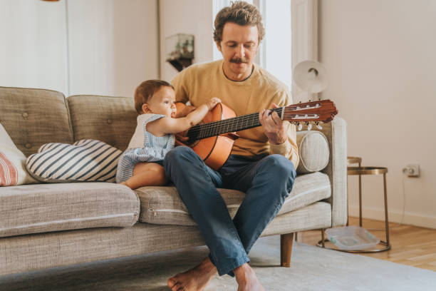istock Father Playing Guitar for Baby 1272413118