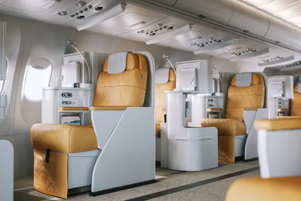 First class seats inside of an airplane.