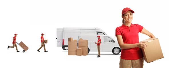 istock Female courier holding a cardboard box and male workers loading transport vans 1272415589