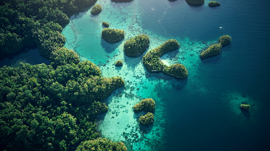 Drone view on rocks and canoes floating on turquoise water in the Halong Bay, Vietnam