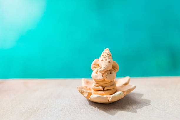 istock Elephant clay sculpture over blurred blue water background 1272416959