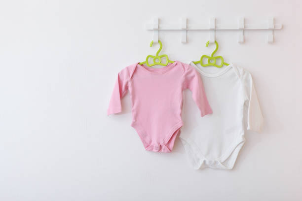 istock Baby clothes on a hanger. Place for text, minimalism. 1272417561