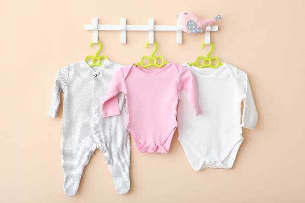 istock Baby clothes on a hanger. Place for text, minimalism. 1272418304