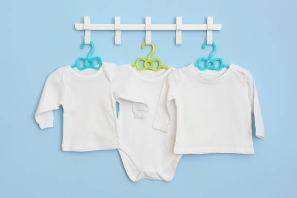 istock Baby clothes on a hanger. Place for text, minimalism. 1272418664
