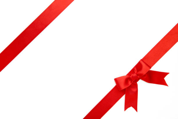 istock Red ribbon with bow with tails isolated on white background. 1272418881