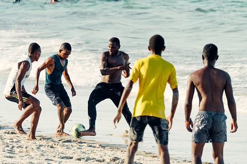 Dar es Salaam Tanzania - February 24, 2019: African boys playing soccer at beach close to Dar es Salaam