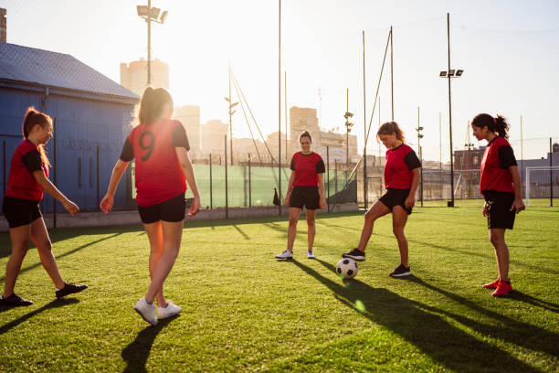 istock Hispanic female footballers doing ball control drill 1272419965