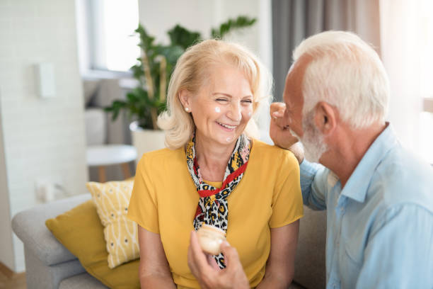 istock Happy senior couple applying face cream. 1272420255