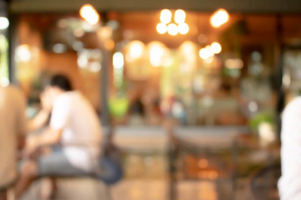 istock abstract blur of interior inside coffee cafe shop background with light effect for design element. Blurred cafe background with bokeh. orange ,red, light. 1272420712