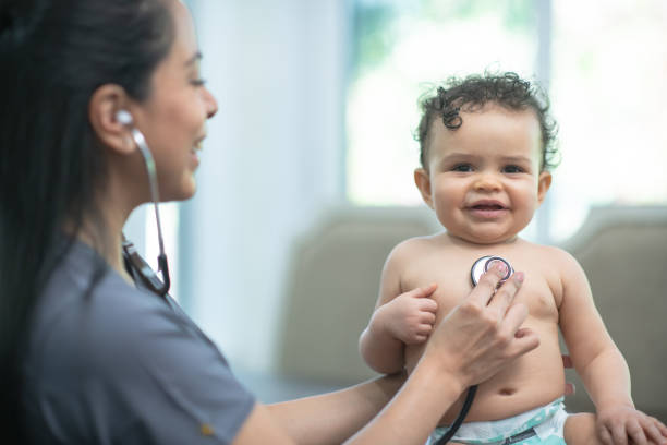 istock Visiting nurse checks on baby 1272421999