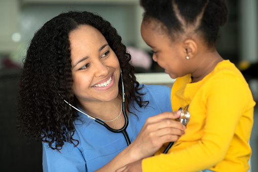 A nurse visits a family's home to do medical check ups.