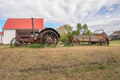 Antique tractor and manure spreader in the village of Rowley, Alberta, Canada
