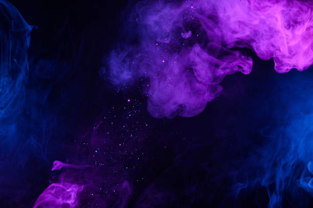 istock Shiny glitter falling in clouds of pink and blue smoke 1272423117