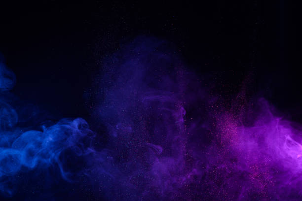 blue and purple smoke with shiny glitter particles - colors color image exploding fog imagens e fotografias de stock