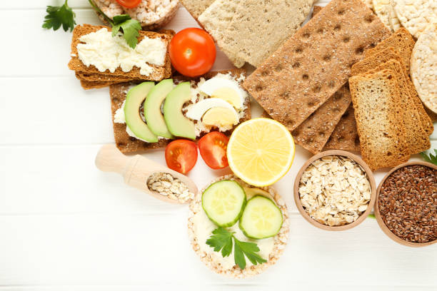 istock Crispbread with cream cheese, eggs and vegetables on white wooden table 1272424238