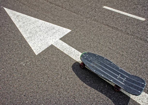 One woman, riding her skateboard on the street far from the city, in nature.