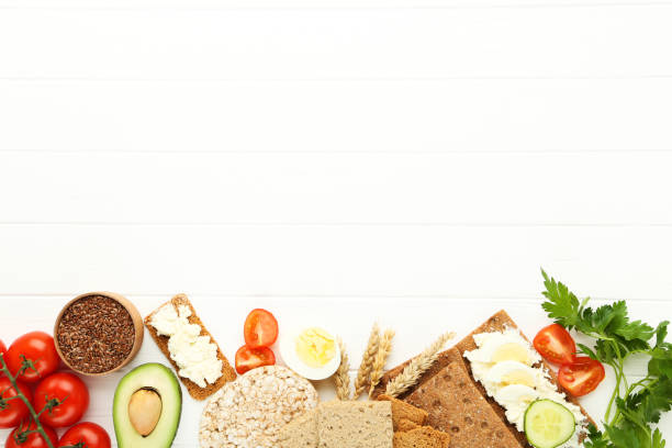 istock Crispbread with cream cheese, eggs and vegetables on white wooden table 1272424458