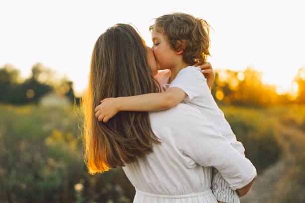 istock Woman playing with her child on the field during sunset 1272424629