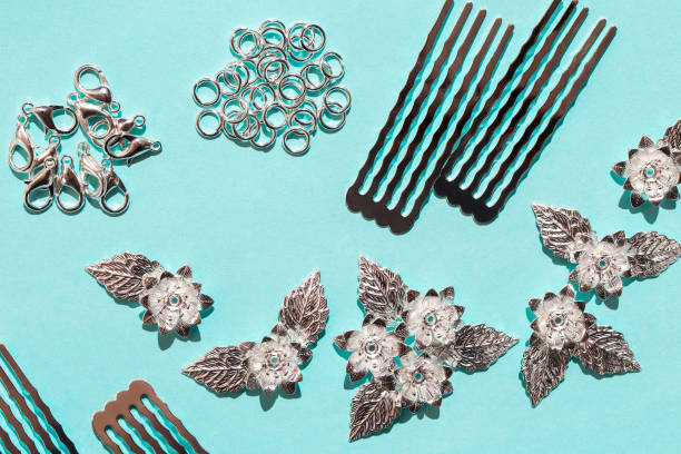 istock Beautiful materials for creating jewelry yourself. Metallic flowers, silvery bases for combs and hairpins close-up. 1272425196