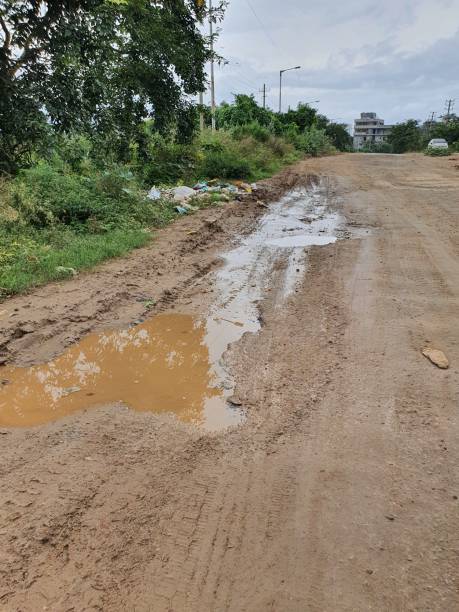 istock Damaged or faulty road condition during monsoon in India. 1272425217