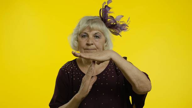 istock Tired senior old woman showing time out, pause gesture looking at camera with upset view, deadline 1272425242