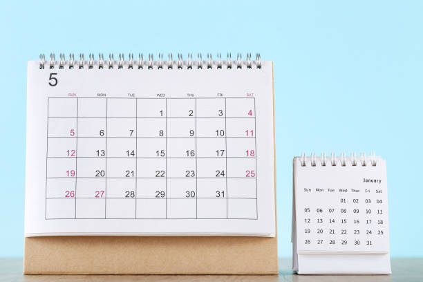 istock Paper calendar pages on blue background 1272426925