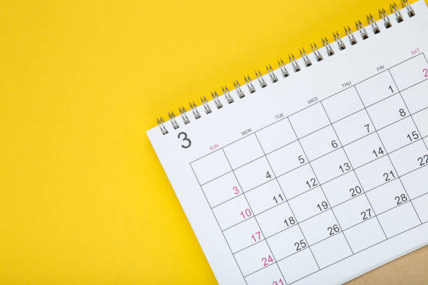 istock Paper calendar page on yellow background 1272427642
