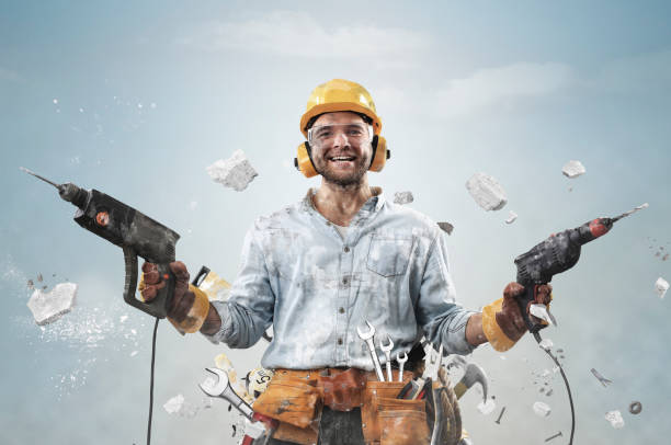 istock Construction worker in dirty clothes with a hammer 1272430734