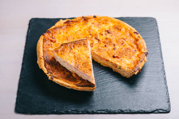 istock Traditional spanish cheese pie with bacon in that dark plate on the table. 1272431824