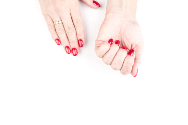 istock Woman's hands with nail red manicure isolated on white background, close up view. Classic red manicure, concept of beauty salon 1272432239