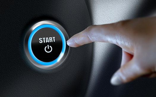 Start title written over car start button on leather dashboard. Business, finance, technology and money concepts over futuristic electronic circuit. High resolution image is designed to crop all your social media, blog or print needs. Produced with Photoshop and 3D software.