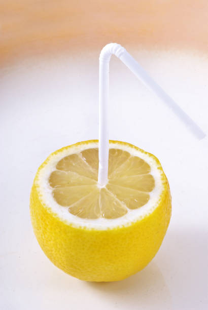 istock Lemon with a straw. Lemon Juice. Creative. 1272434581