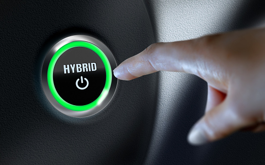 Hybrid title written over car start button on leather dashboard. Business, finance, technology and money concepts over futuristic electronic circuit. High resolution image is designed to crop all your social media, blog or print needs. Produced with Photoshop and 3D software.
