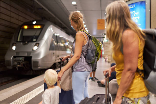 istock A mother stands with her son by the hand on the subway platform while the train pulls in 1272435934