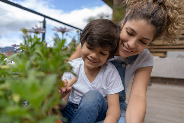 istock Mother teaching her son how to plant a tree 1272437360