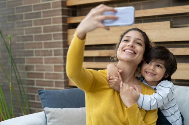 istock Happy mother taking a selfie with her son at their terrace 1272437366