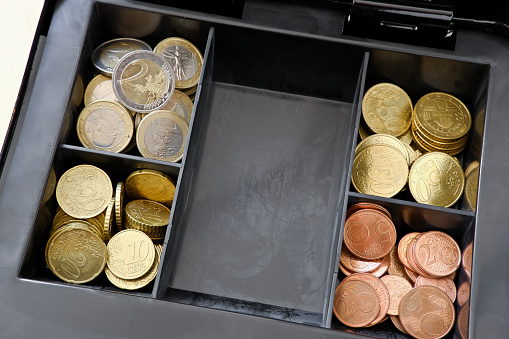 View into a cash box with Euro coins. The paper currency is missing …