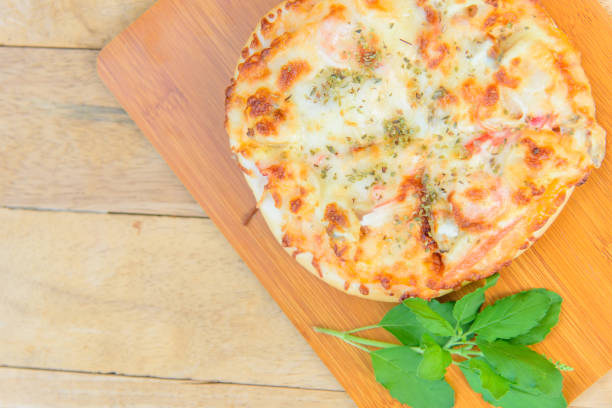 istock pizza Hawaiian Home made on wood plate 1272439344