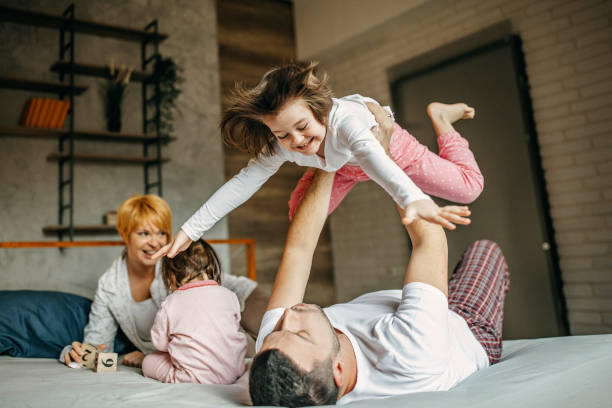 istock Family cuddling in bed 1272439487