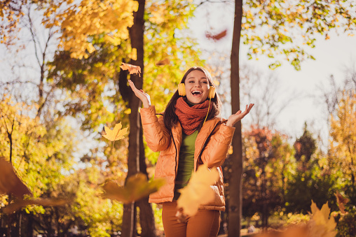 Cheerful woman walking in the autumn forest after the rain