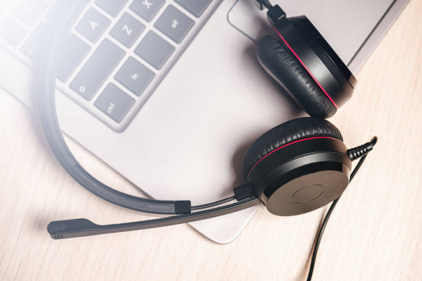 istock Headphones with microphone on laptop. Concept call distance. 1272442077