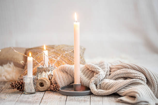 istock Cozy still life with burning candles and a knitted sweater. 1272442838