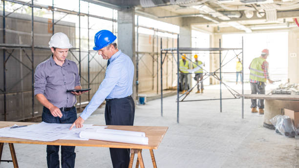 istock Architect and investor discussing plans on a construction site 1272443484